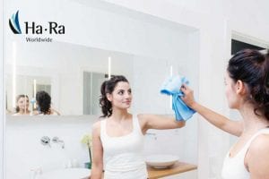 Housekeeper cleaning mirror with a Ha-Ra microfibre cloth